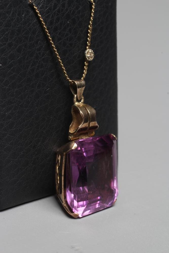 AN AMETHYST PENDANT, the oblong facet cut stone claw set to a plain unmarked frame with hinged bale, Image