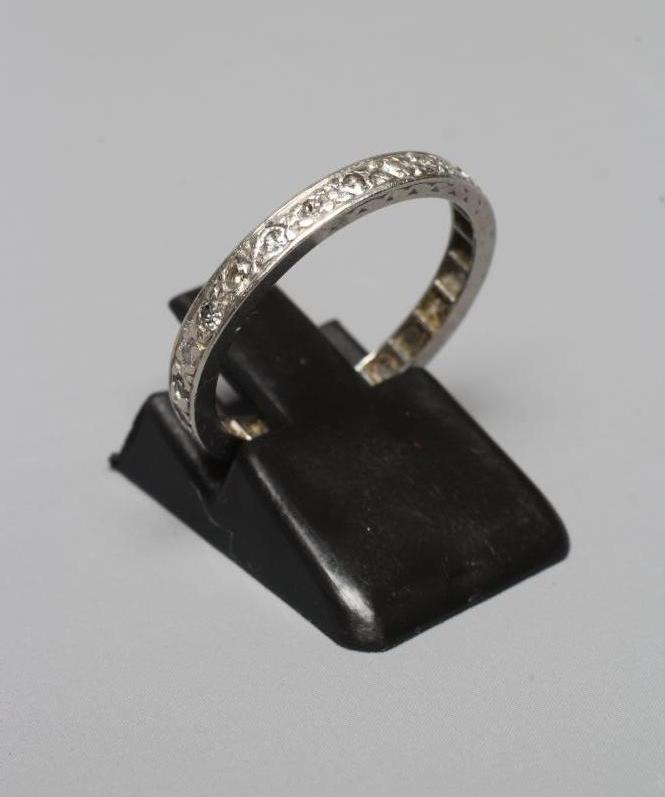 A DIAMOND ETERNITY RING, the mix cut small stones point set to an engraved shank stamped PLAT, size Image