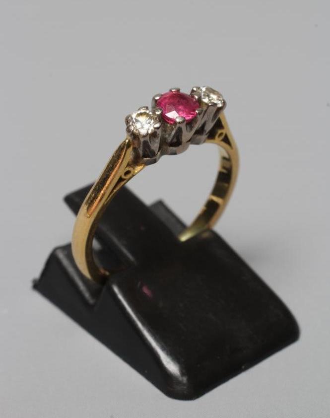 A THREE STONE RUBY AND DIAMOND RING Image