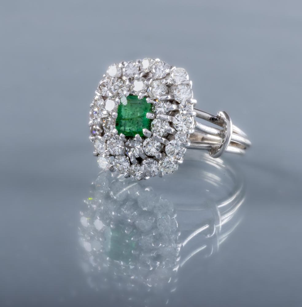 AN EMERALD AND DIAMOND CLUSTER COCKTAIL RING Image