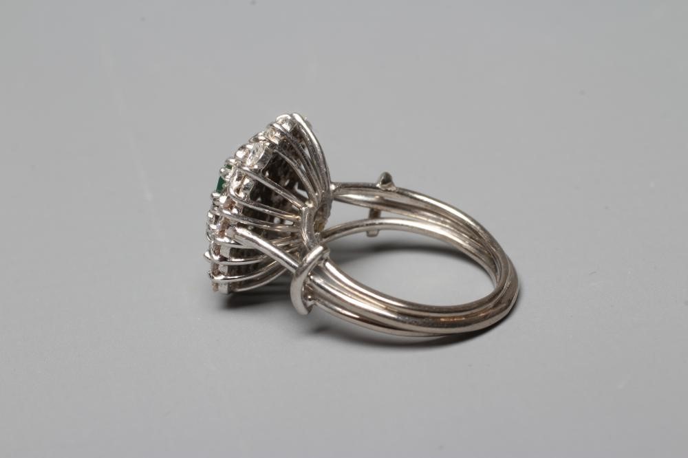 AN EMERALD AND DIAMOND CLUSTER COCKTAIL RING Image