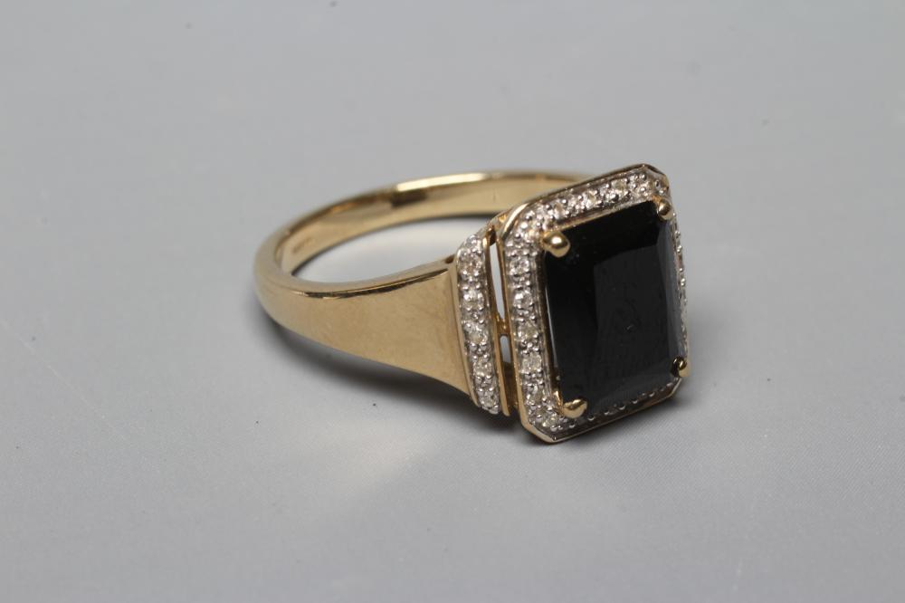 A GARNET AND DIAMOND CLUSTER DRESS RING Image