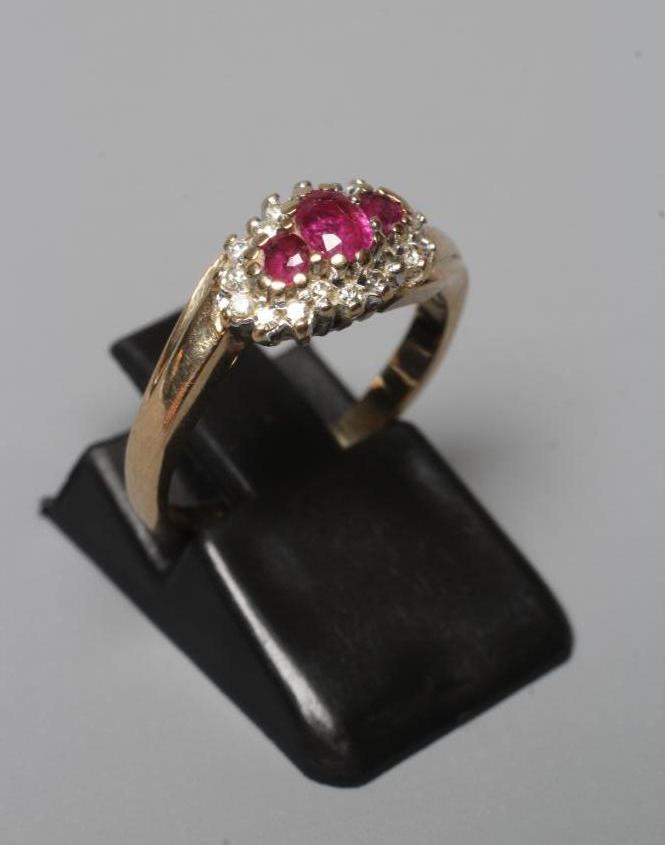 A RUBY AND DIAMOND CROSSOVER RING Image