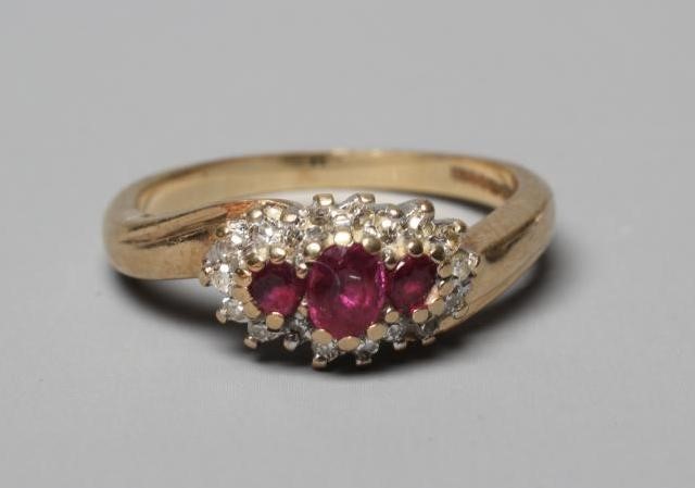A RUBY AND DIAMOND CROSSOVER RING Image