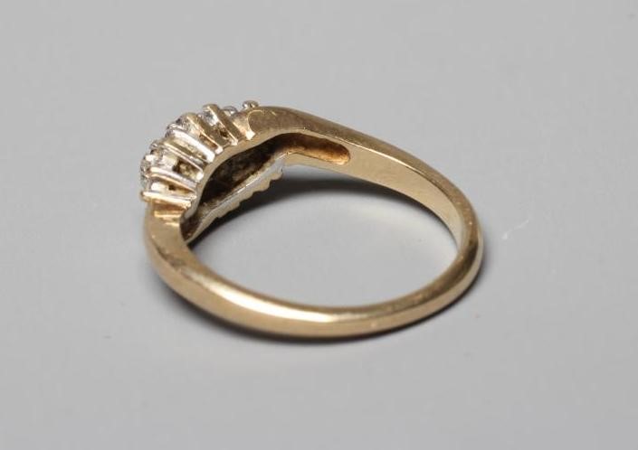 A RUBY AND DIAMOND CROSSOVER RING Image