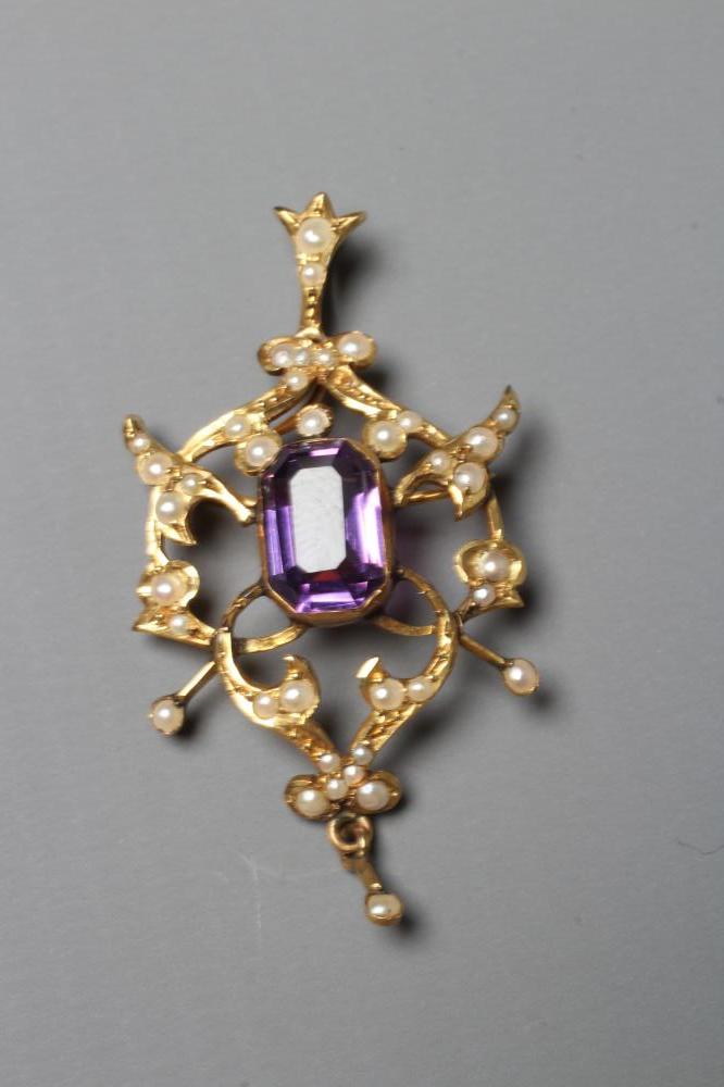 AN EDWARDIAN AMETHYST AND SEED PEARL PENDANT of typical open shield form centred by a step cut Image