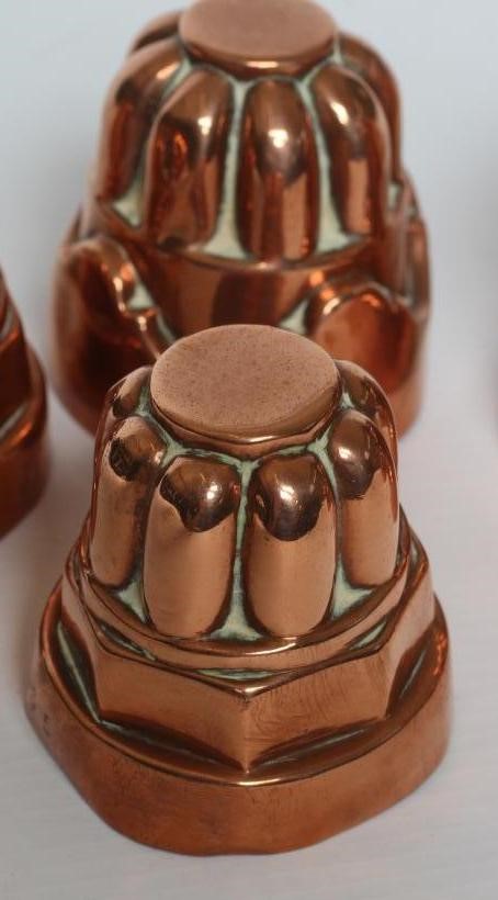 TWO SETS OF THREE SMALL VICTORIAN COPPER JELLY MOULDS of fluted tapering cylindrical form Image