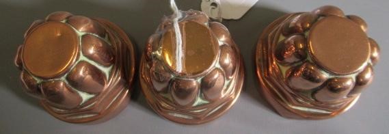 TWO SETS OF THREE SMALL VICTORIAN COPPER JELLY MOULDS of fluted tapering cylindrical form Image