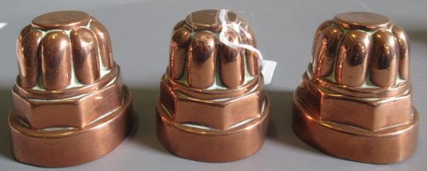 TWO SETS OF THREE SMALL VICTORIAN COPPER JELLY MOULDS of fluted tapering cylindrical form Image
