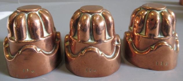 TWO SETS OF THREE SMALL VICTORIAN COPPER JELLY MOULDS of fluted tapering cylindrical form Image