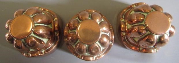 TWO SETS OF THREE SMALL VICTORIAN COPPER JELLY MOULDS of fluted tapering cylindrical form Image