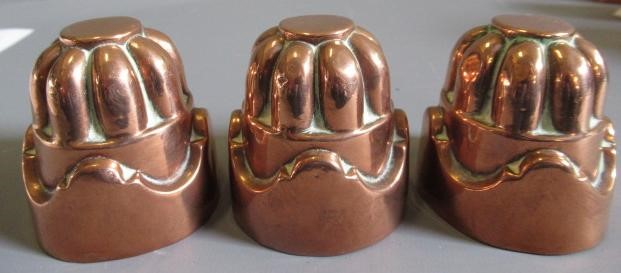 TWO SETS OF THREE SMALL VICTORIAN COPPER JELLY MOULDS of fluted tapering cylindrical form Image