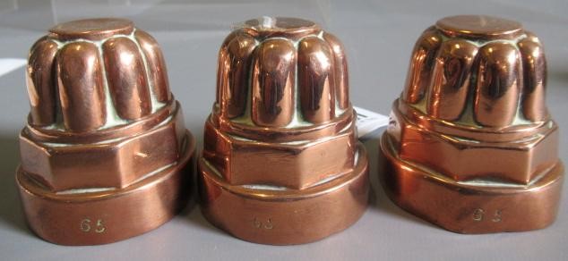 TWO SETS OF THREE SMALL VICTORIAN COPPER JELLY MOULDS of fluted tapering cylindrical form Image