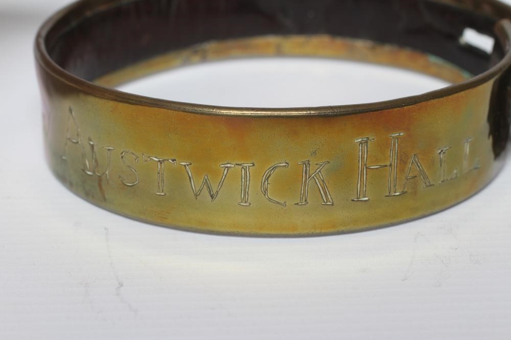 A BRASS DOG COLLAR, early 19th century, engraved 'T R Clapham, Austwick Hall', leather lined, 4 1/2" Image