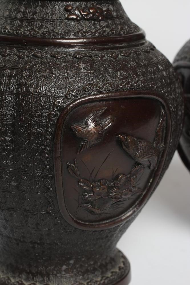 A PAIR OF CHINESE BRONZE VASES of two handled baluster form with cast decoration including high Image