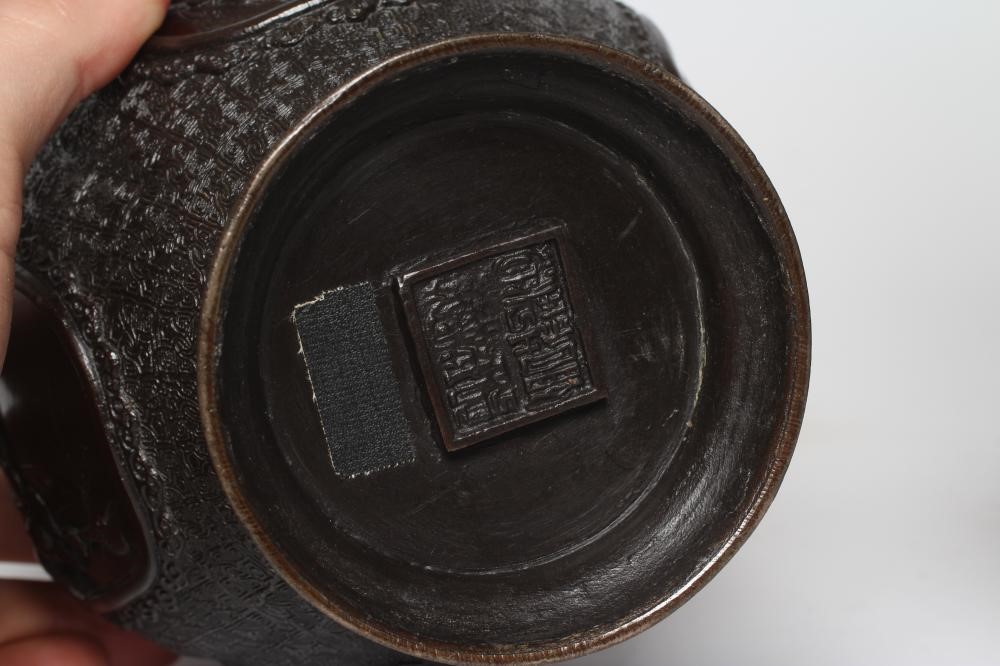 A PAIR OF CHINESE BRONZE VASES of two handled baluster form with cast decoration including high Image