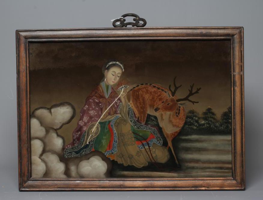 A CHINESE REVERSE PAINTING ON GLASS of a young lady in landscape holding a flower with a deer beside Image