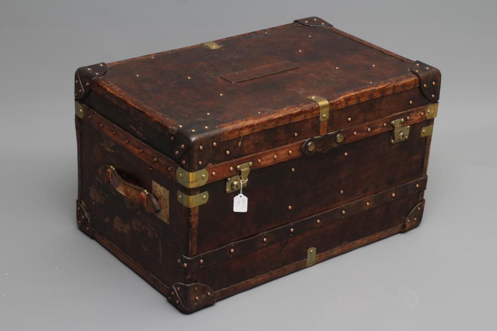A STUDDED TRAVEL TRUNK, early 20th century, made of wood and leather covered, with two side handles, Image