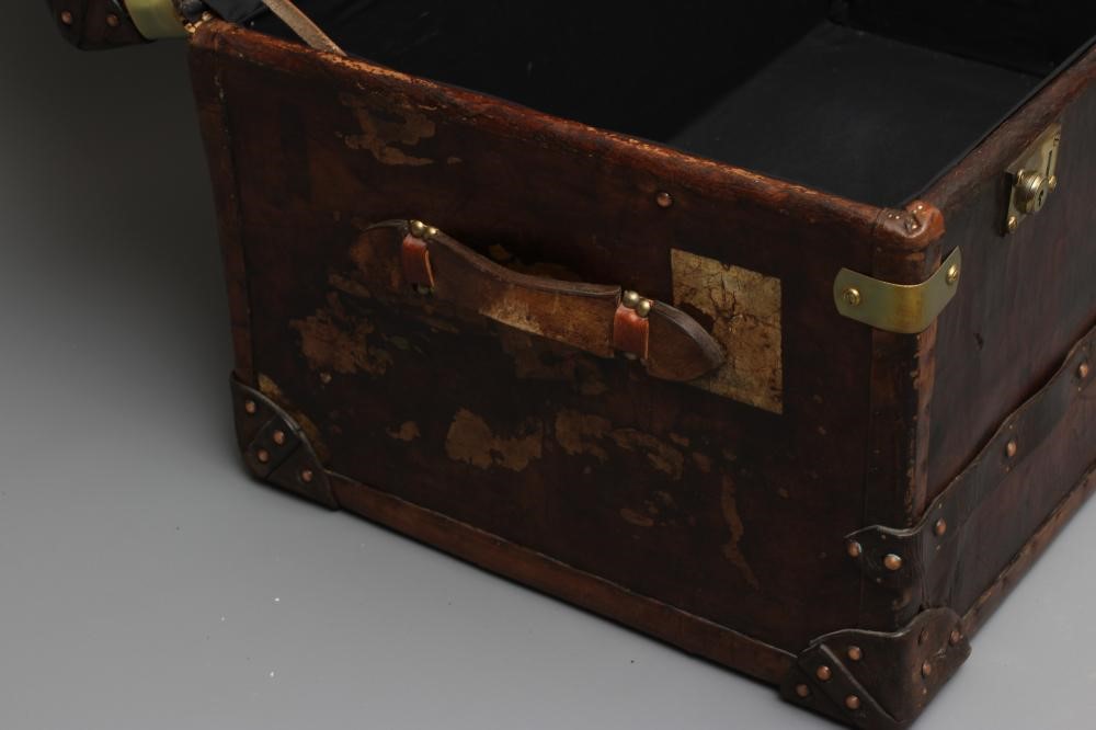A STUDDED TRAVEL TRUNK, early 20th century, made of wood and leather covered, with two side handles, Image