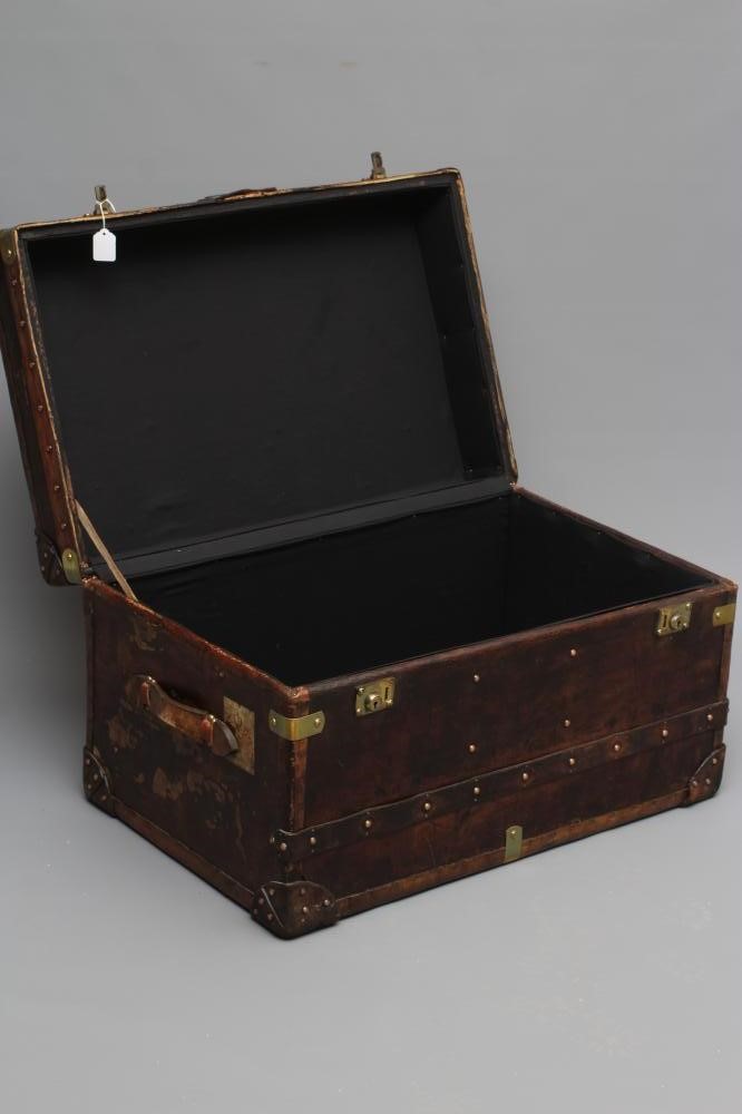 A STUDDED TRAVEL TRUNK, early 20th century, made of wood and leather covered, with two side handles, Image