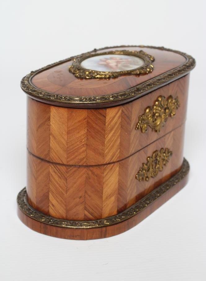 A LOUIS XV STYLE KINGWOOD OVAL TRINKET BOX, early 20th century, with metal mounts and inset Sevres Image