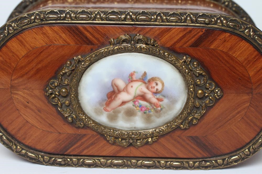 A LOUIS XV STYLE KINGWOOD OVAL TRINKET BOX, early 20th century, with metal mounts and inset Sevres Image