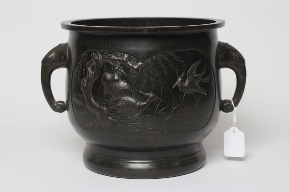 A CHINESE BRONZE JARDINIERE cast in relief with exotic birds set within two panels, flanked by two Image