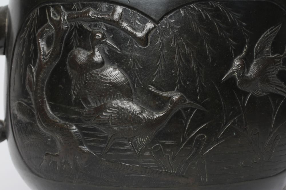 A CHINESE BRONZE JARDINIERE cast in relief with exotic birds set within two panels, flanked by two Image