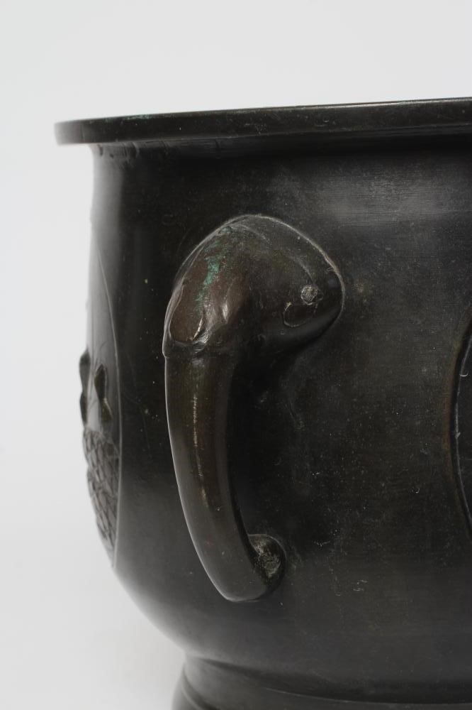 A CHINESE BRONZE JARDINIERE cast in relief with exotic birds set within two panels, flanked by two Image