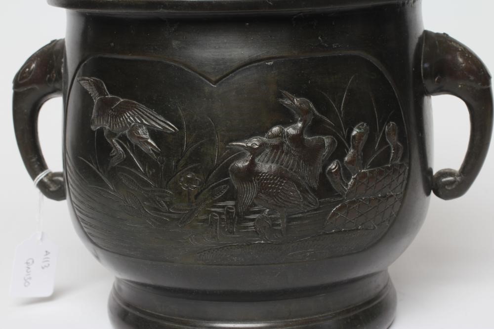 A CHINESE BRONZE JARDINIERE cast in relief with exotic birds set within two panels, flanked by two Image