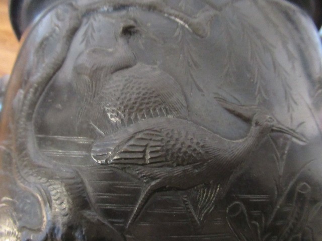 A CHINESE BRONZE JARDINIERE cast in relief with exotic birds set within two panels, flanked by two Image