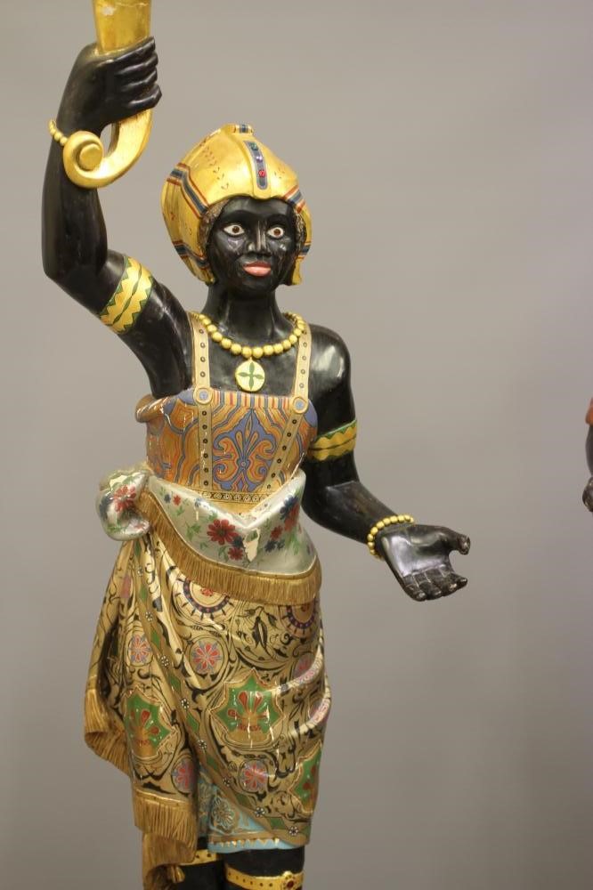 A PAIR OF HAND CARVED POLYCHROME AND GILDED TORCHERE BLACKAMOORS Image