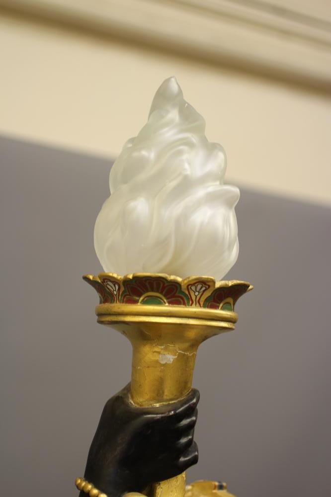 A PAIR OF HAND CARVED POLYCHROME AND GILDED TORCHERE BLACKAMOORS Image