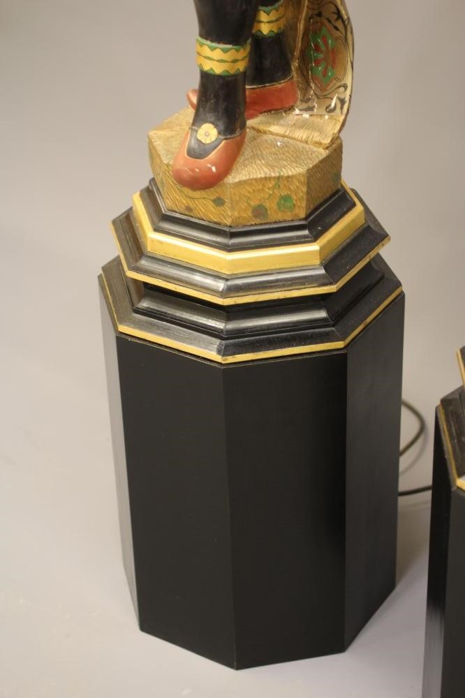 A PAIR OF HAND CARVED POLYCHROME AND GILDED TORCHERE BLACKAMOORS Image