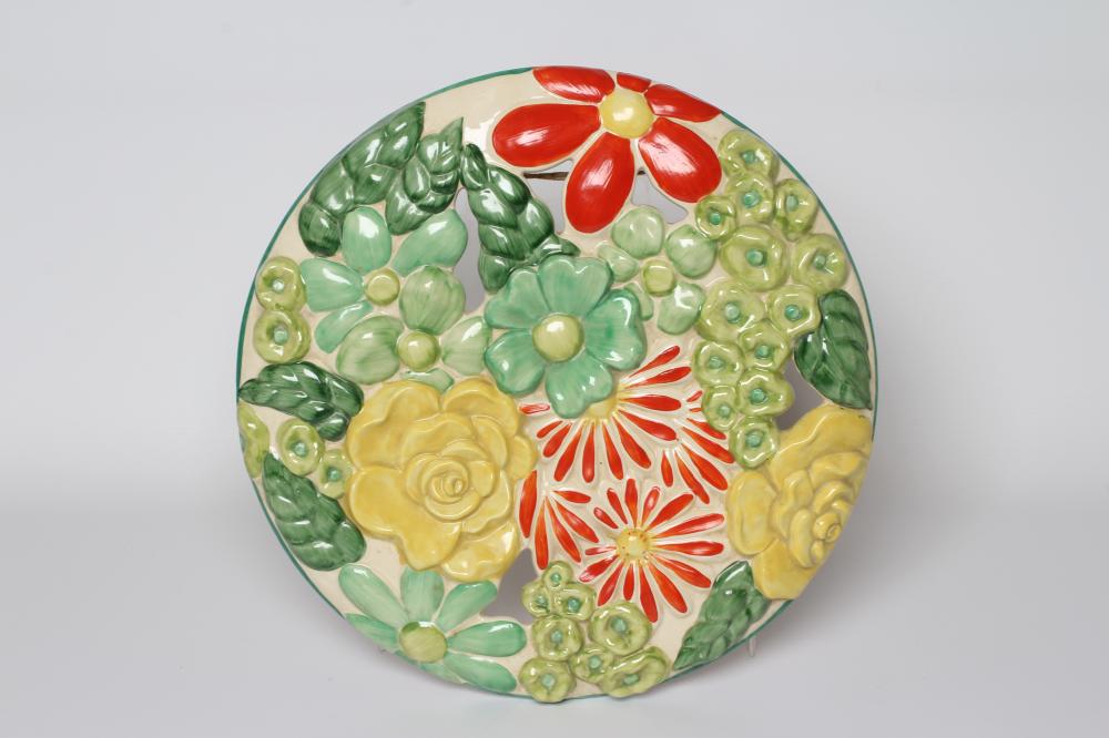 A CLARICE CLIFF WILKINSON POTTERY BIZARRE ART DECO MARGUERITE WALL MEDALLION painted in bright Image