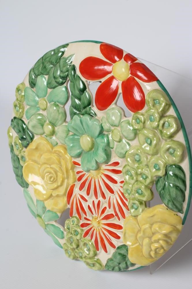 A CLARICE CLIFF WILKINSON POTTERY BIZARRE ART DECO MARGUERITE WALL MEDALLION painted in bright Image