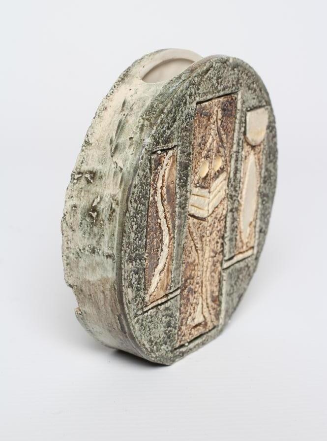 A TROIKA POTTERY SMALL WHEEL VASE with typical incised panels of a portcullis and fish in shades of Image
