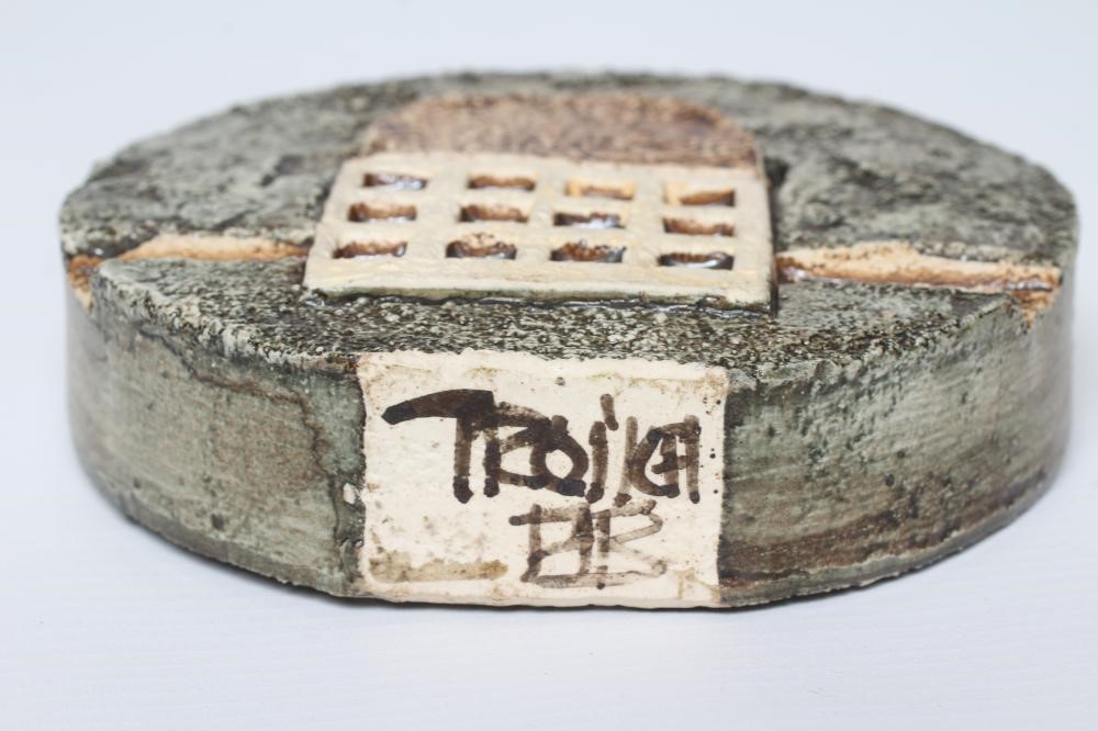 A TROIKA POTTERY SMALL WHEEL VASE with typical incised panels of a portcullis and fish in shades of Image
