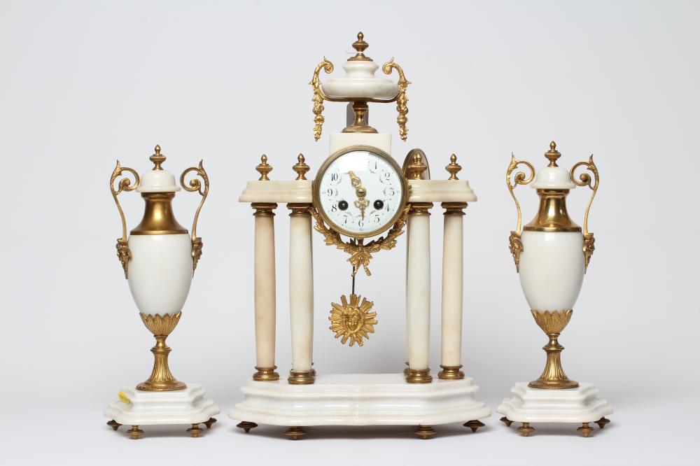 A FRENCH WHITE ONYX AND GILT METAL CLOCK GARNITURE Image