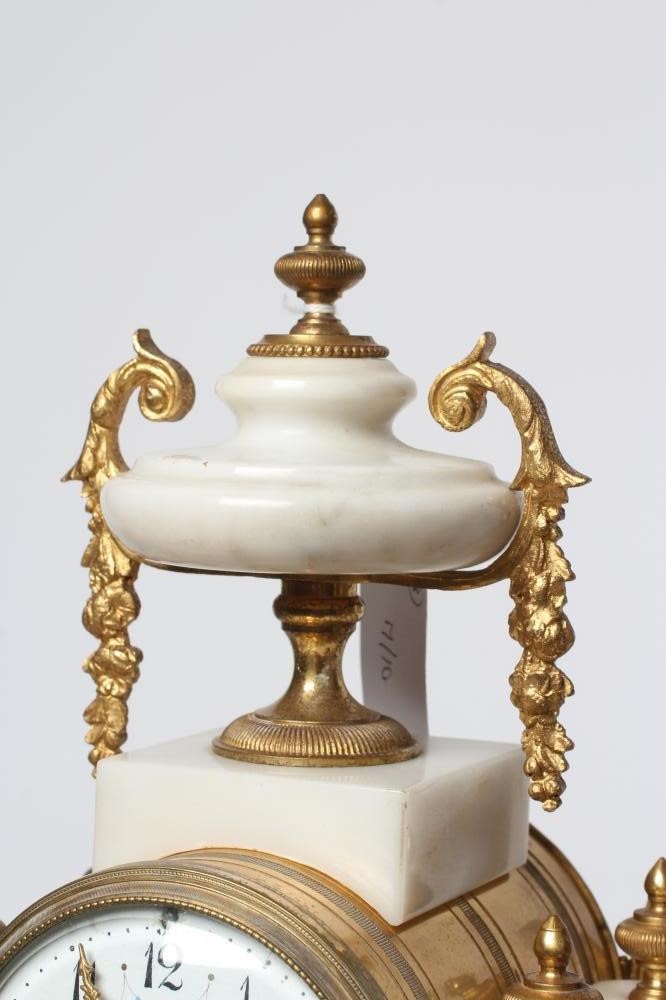 A FRENCH WHITE ONYX AND GILT METAL CLOCK GARNITURE Image