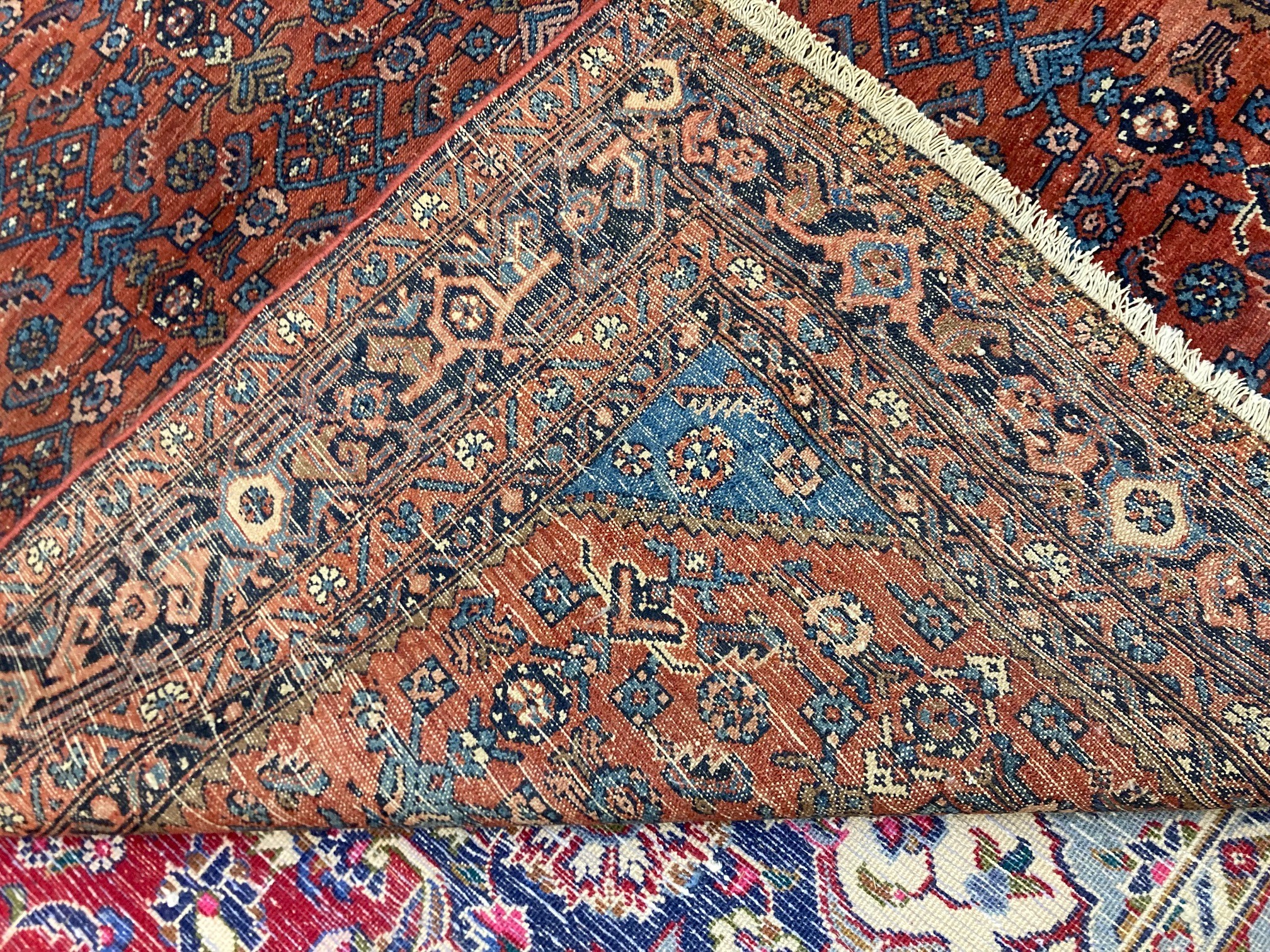 A NORTHWEST PERSIAN TRIBAL RUG with dark red central field decorated with floral tendrils contained Image