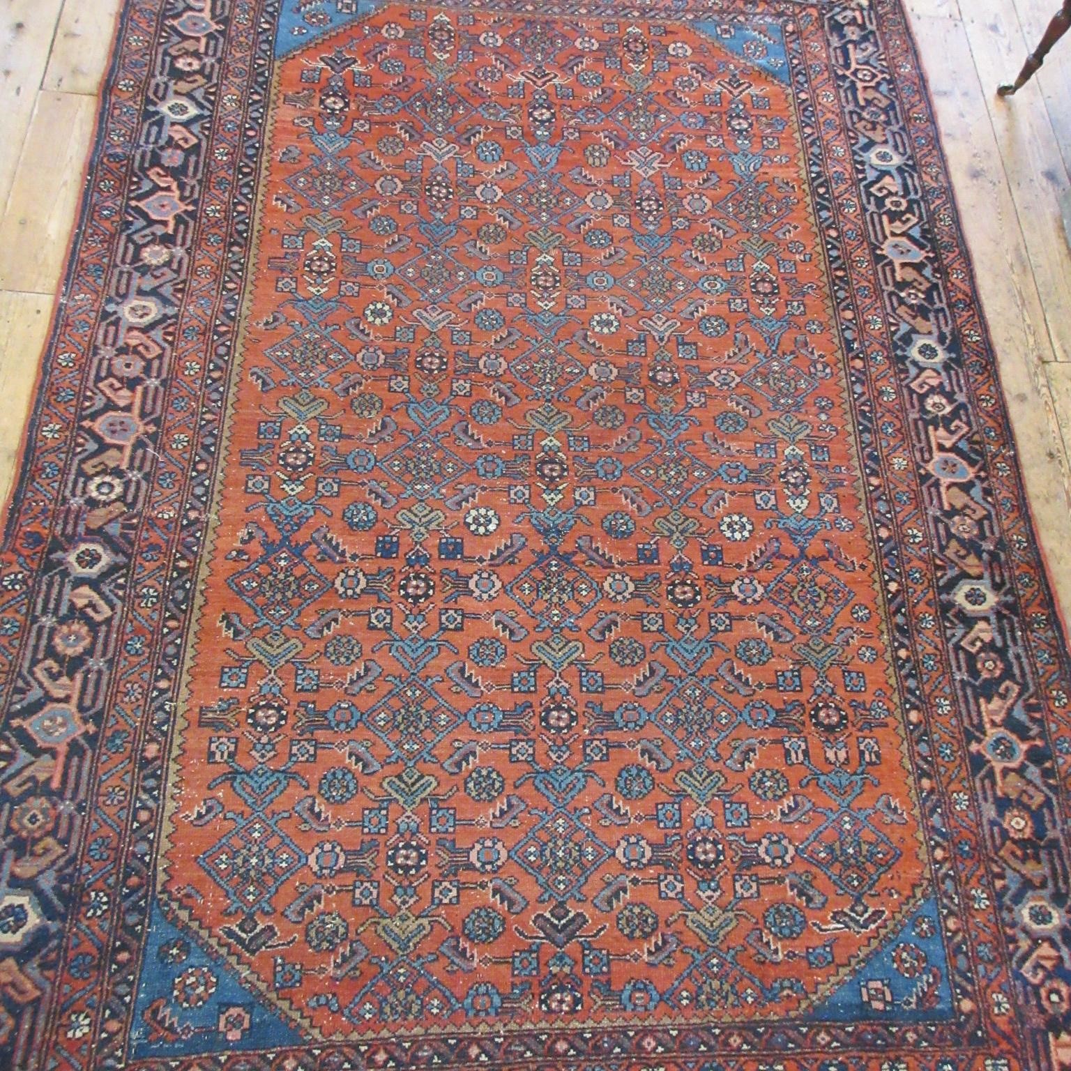 A NORTHWEST PERSIAN TRIBAL RUG with dark red central field decorated with floral tendrils contained Image