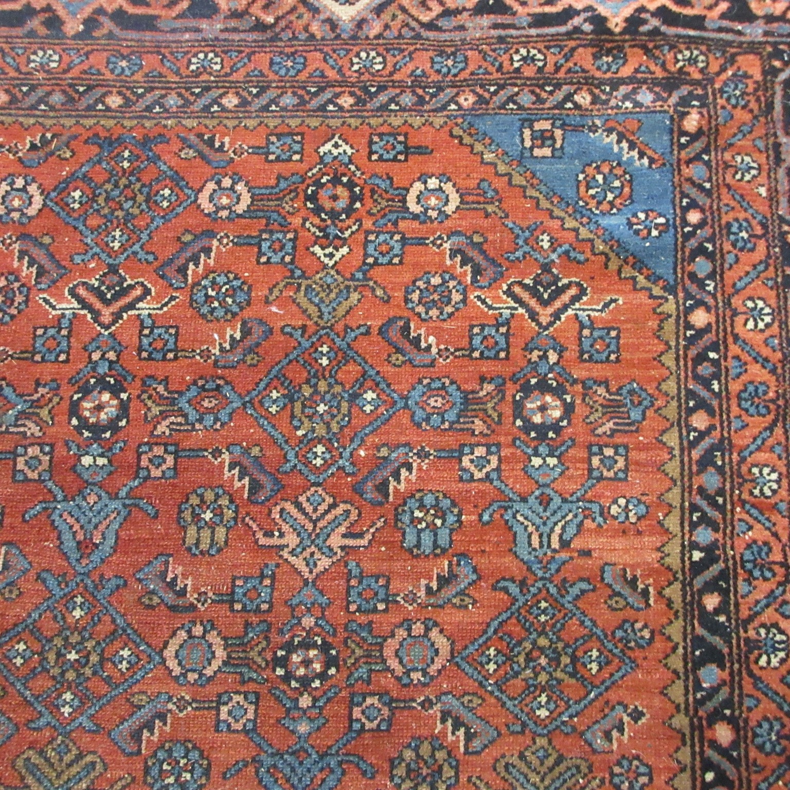 A NORTHWEST PERSIAN TRIBAL RUG with dark red central field decorated with floral tendrils contained Image