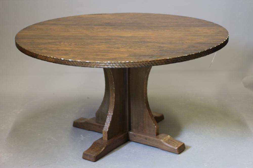 A DAVID LANGSTAFF ADZED OAK DINING TABLE, the circular top with adzed edge, raised on waisted Image
