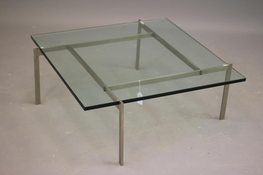 A GLASS AND POLISHED STEEL COFFEE TABLE, modern, the rounded square glass top on a square section Image
