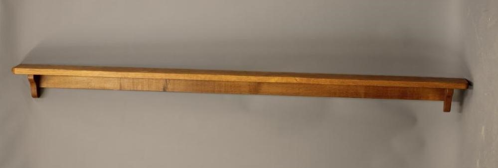 A ROBERT THOMPSON ADZED OAK WALL SHELF of rounded oblong form on ogee end brackets Image