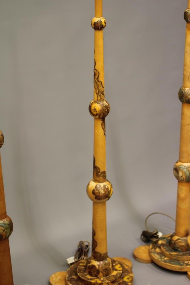 A SET OF FOUR ART DECO LIGHT BEECH STANDARD LAMPS BY CYRIL M ROYLE painted with flowers and foliage Image