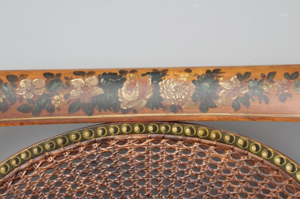 AN EDWARDIAN CANED AND FLORAL PAINTED ELBOW CHAIR Image