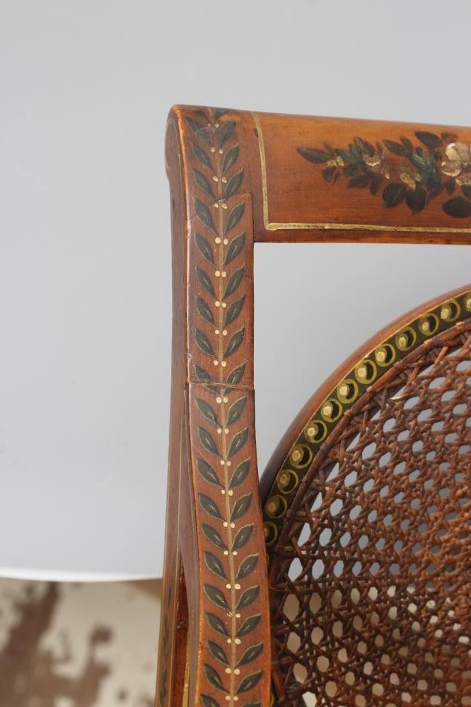 AN EDWARDIAN CANED AND FLORAL PAINTED ELBOW CHAIR Image