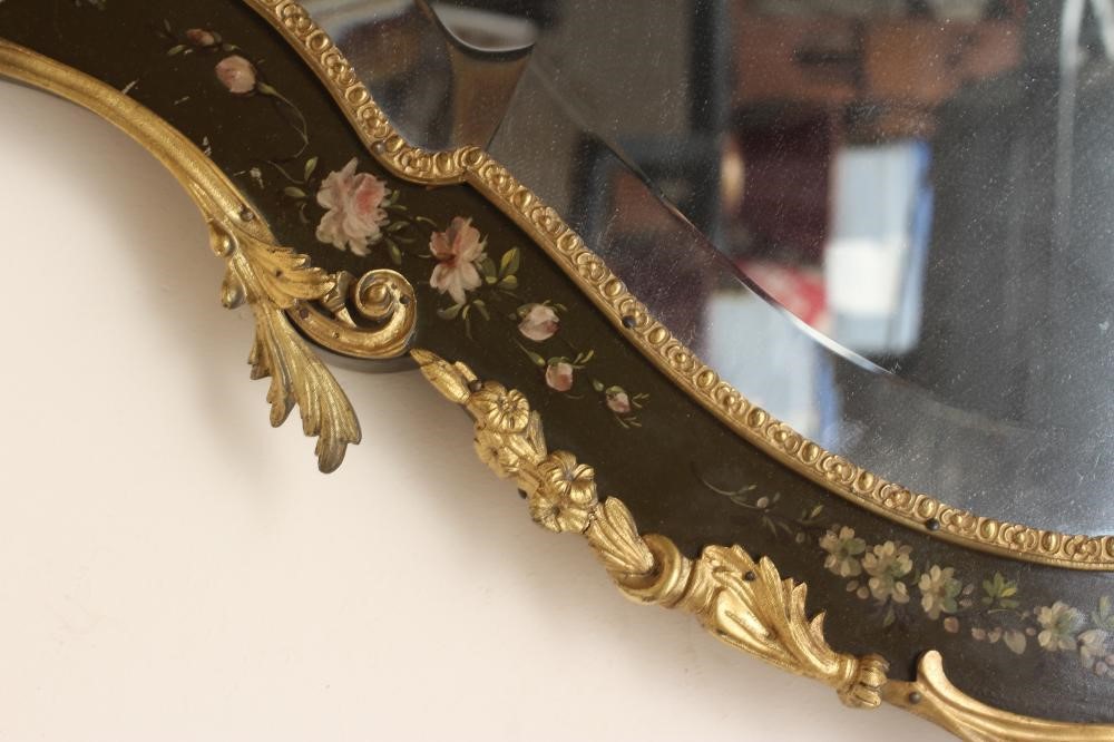 A PAINTED AND GILT METAL MOUNTED WALL MIRROR, 20th century, of shield form in the French rococo Image